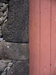 Detail on a wooden door and porous stone wall of volcanic origin. In a house in the town of Santa Cruz das Flores. Flores Island.
