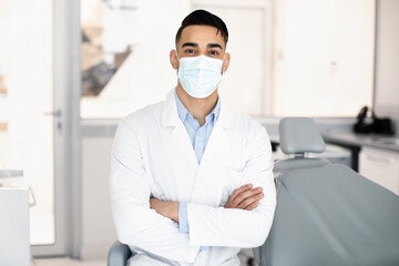 Dental Services. Portrait Of Handsome Arab Dentist In Uniform And Medical Mask