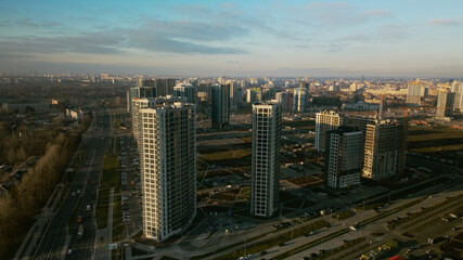 Fototapeta premium Construction site. Construction of modern multi-storey buildings. Against the background of the blue sky. Aerial photography.