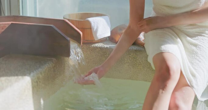 hand scoop up hot spring