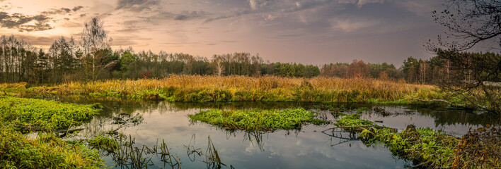 Sunset over a small river in late fall.