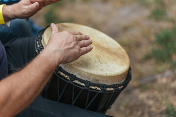 musician playing djembe, performing at a concert