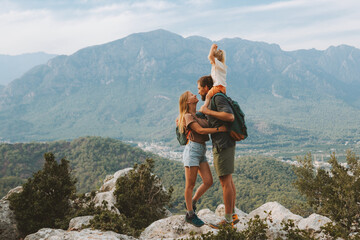 Family hugging couple with child traveling outdoor hiking in mountains with kid active vacations...