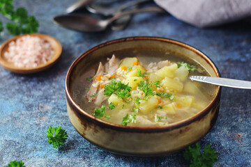 A bowl with chicken soup with pasta