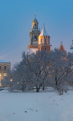 Wawel castle and cathedral covered with snow on winter night, Krakow, Poland