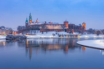 Krakow winter, night Wawel Castle over Vistula river, snow, Poland