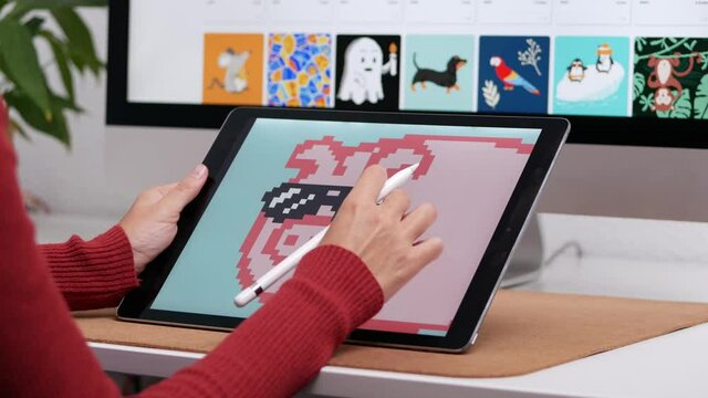 Unrecognizable woman illustrator painting NFT on computer