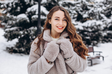 Pretty girl having a walk in park at winter