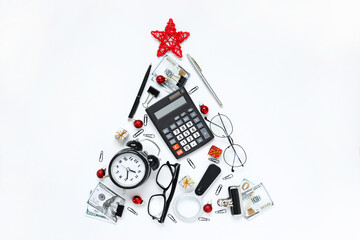 christmas tree made of stationery, calculator, glasses, alarm clock, magnifier, red balls, Concept of the holiday Christmas and New Year in the office, Creative design ideas