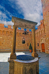 Courtyard of the Palazzo Chigi Saracini with medieval walls and fountains in Siena. Italy, Europe