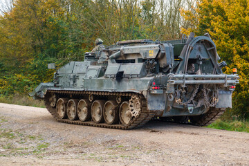 Fototapeta premium close up rear three-quarter shot of a British Army Challenger Armored Repair and Recovery Vehicle (CRARRV) in action on a military training exercise, salisbury plain wiltshire UK