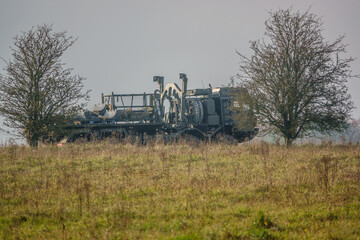 Fototapeta premium MAN SV 8x8 army logistics truck vehicle with cargo driving along a mud track in action on a military exercise, Salisbury Plain UK
