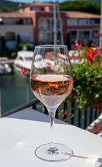Summer on French Riviera Cote d'Azur, drinking cold rose wine from Cotes de Provence on outdoor terrase in Port Grimaud, Var, France