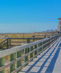 The boardwalk along the dunes on the beach of Gulf of Mexico in Destin, Florida