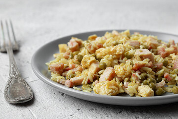 Cantonese rice or Chinese fried rice in a plate on a dark wooden old table, top view