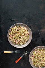 Two plates with traditional Cantonese or Chinese fried rice on a dark table, top view