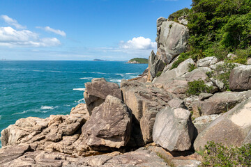 Rocks on cliffs and ocean in background