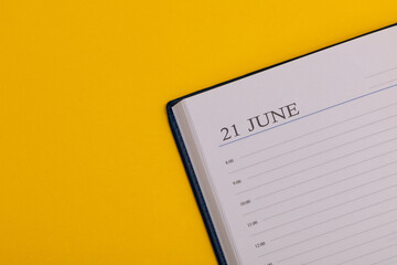 Notepad or diary with the exact date on a yellow background. Calendar for June 21 - summer time. Space for text.