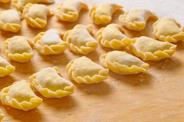 Beautiful delicious dumplings on a wooden Board, cooked at home.