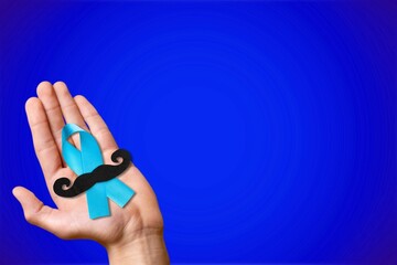 November. Blue ribbon in hands. Awareness prostate cancer of men health