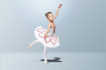 Tips on toes. Young graceful ballerina dancing alone on background.