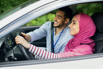 Caring Arab Husband Teaching His Muslim Wife In Hijab To Drive Car