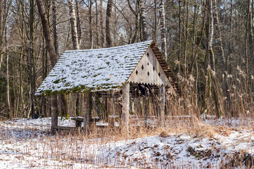 Forest gazebo. A place in the woods for travelers to relax. A table and benches in the forest.
