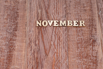 November month. The name of the months on a wooden background. Template for a calendar.