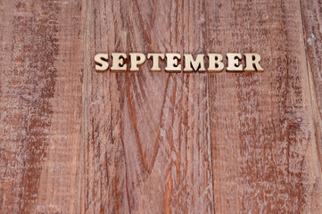 September month. The name of the months on a wooden background. Template for a calendar.