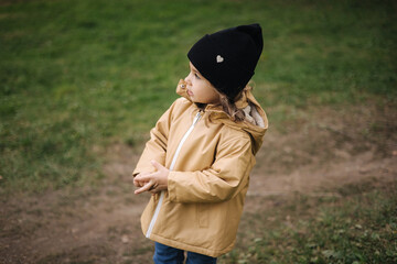 Cute little girl waking in forest. Beautiful little daughter spend time outdoors in autumn time