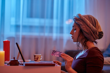 Experienced young fortune-teller doing a card reading