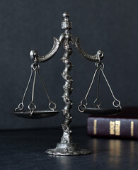 Old rustic vintage ancient balance weighing scale with closed Holy Bible Book on dark background....