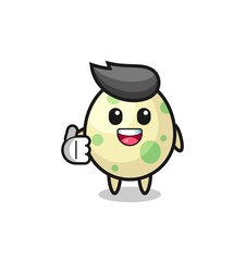 spotted egg mascot doing thumbs up gesture
