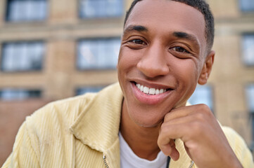 Close up picture of a smiling dark-skinned guy