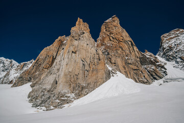 Alpine mountain landscape of Mont Blanc Masiff, Chamonix, France. Alpine peaks, Aiguille du Midi and other famous alpine mountains. Alpinism, climbing, glaciers and snow.