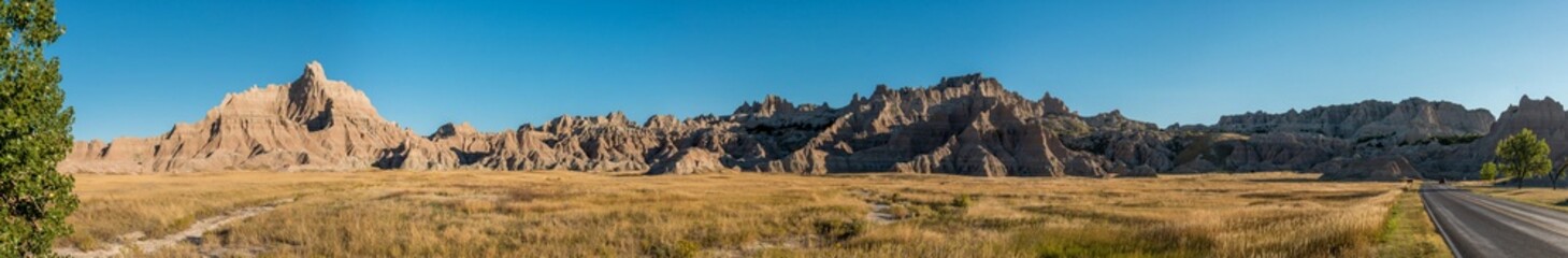 Jagged sandstone mountains illuminated from the sun in Badlands National Park