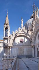 Closeup on the exterior Saint Mark's Basilica in Venice, Italy. Bright sunny day with blue sky.