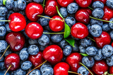Water drops on ripe sweet blueberry.Gooseberries, blueberries,cherry, mulberry, raspberries, white and red currants. Vegan and vegetarian concept.Texture blueberry berries close up