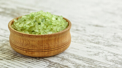 Pieces of aloe vera with pulp on a wooden background.Aloe vera essential oil or serum with sliced Aloe vera.skin care and hair care concept.Aloe leaf slices with drops