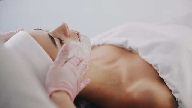 Clearing raw skin. Close up view of woman that lying down in spa salon and have face cleaning procedure
