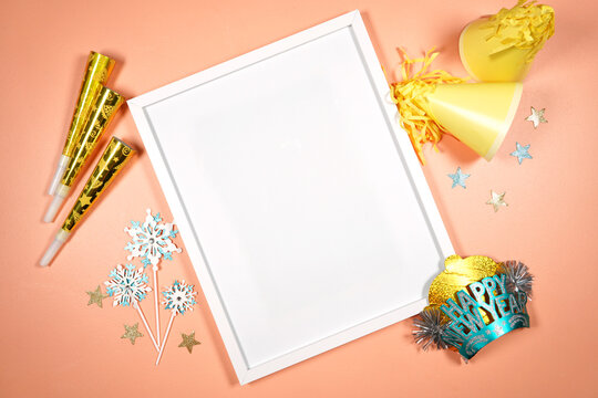Wall art poster print frame product mockup. New Year theme SVG craft product mockup styled with party hats and blowers decorations. Gold and blue theme creative composition flatlay.