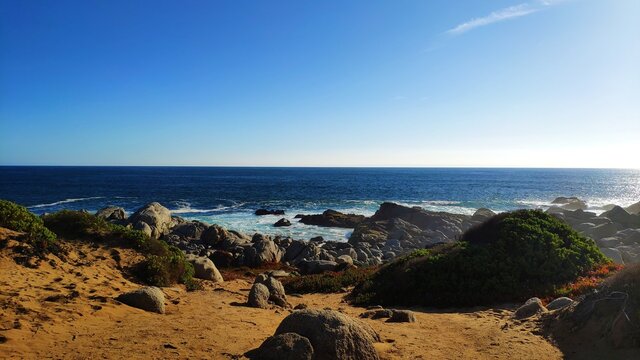 Blue sky, horizon and rocky beach at Punta de Tralca, El Quisco, Chile.
