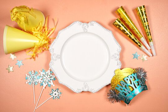 Dinner plate product mockup. New Year theme SVG craft product mockup styled with party hats and blowers decorations. Gold and blue theme creative composition flatlay.