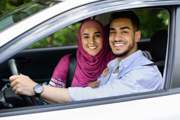 Portrait Of Happy Middle Eastern Spouses Posing In Their New Automobile