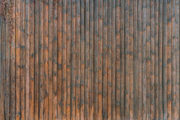 Old tall wooden wall assembled of beams or vertical logs. House. Fence. History .Historical. Fence....