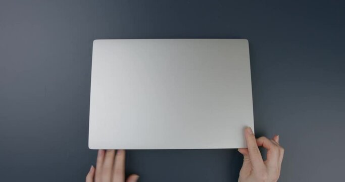 Close-up. Office table. Hands of a girl working on a laptop. Flat lay
