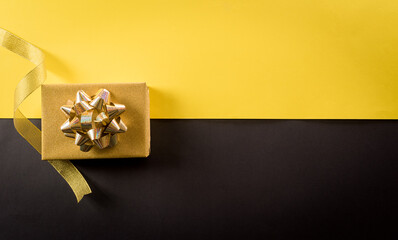 Top view of Black Friday Christmas gift box and golden ribbon on