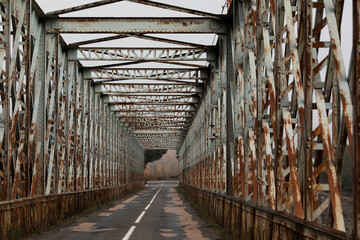 Old rusty iron bridge over the Peña reservoir, in the Jacetania region, Huesca province, Aragon,...