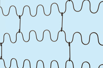 Zig zag springs of a folding bed isolated on blue