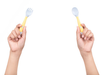 Hand holding kids spoon and fork isolated on white background.